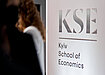 The Kyiv School of Economics logo and name in silver on a white wall. Photo source: Kyiv School of Economics.